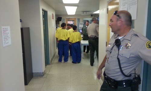 Teenagers being escorted into the jail