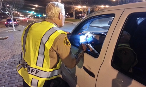 Deputy Sheriff checking Drivers Licenses