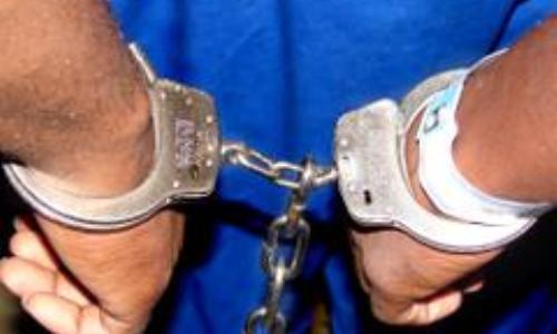 Inmate in handcuffs (stock photo)
