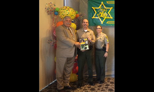 Sheriff Scott presents plaque to Captain Bolin and Sergeant Sosa