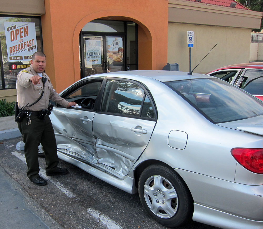 Deputy and a damaged vehicle